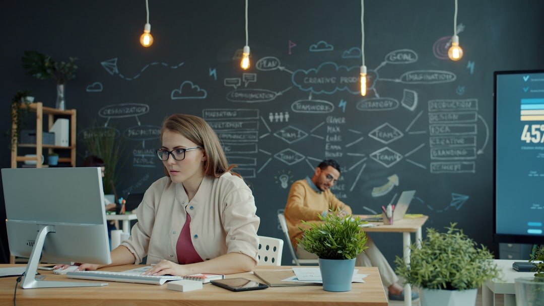 Tech startup team working in modern office with laptops